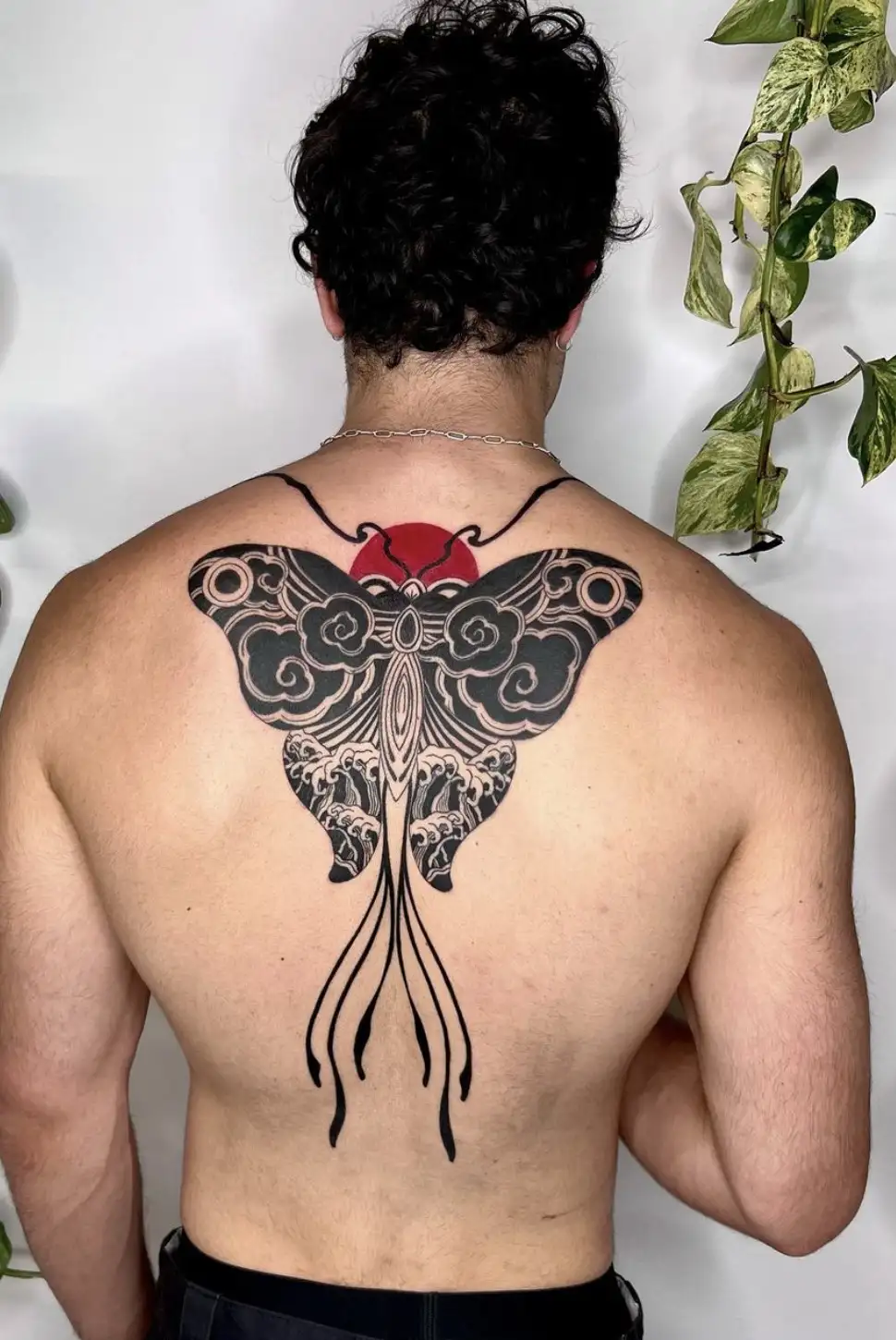 Butterfly back tattoo with ornamental patterns and red sun by Ayah at Omnia Tattoo Melbourne